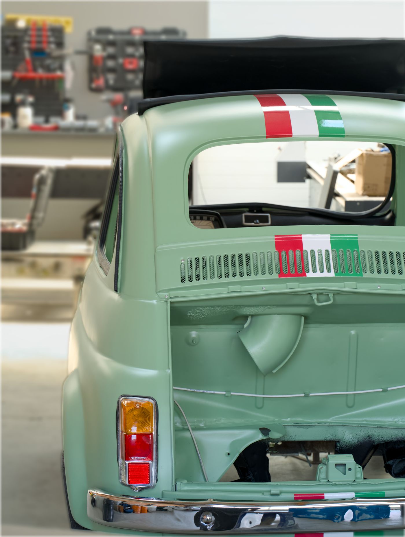 Car in a body shop with rear panel and bumper work in progress